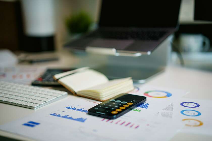 Plusieurs éléments, un cahier pour noter, une calculatrice, un ordinateur et des documents